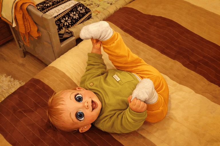 newborn mike playing while resting on bed
